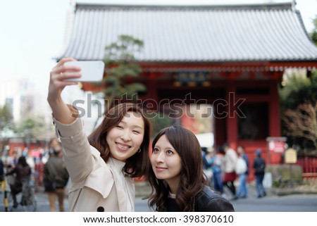 Tourist women taking selfie at Tokyo