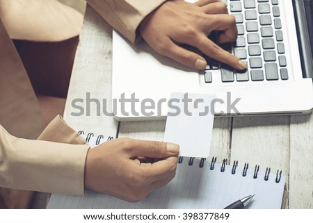 Hands holding credit card and using laptop. Online shopping vintage tone.