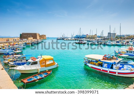 Old venetian harbor with boats in Heraklion, Crete island, Greece Royalty-Free Stock Photo #398399071