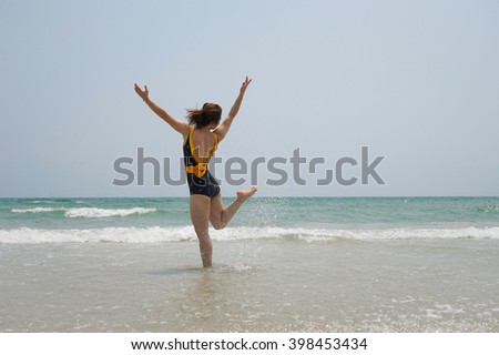 woman jumping on the beach