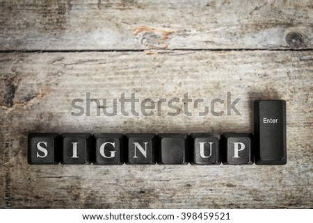 keys on a wooden table with the words sign up ,conceptual