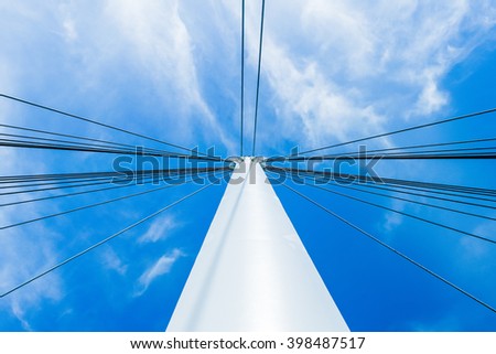 Venice, Italy - 03 August 2012:  View looking up the central mast of the bridge in San Giuliano Park, Venice, Italy, against a blue summer sky. An image depicting contemporary architecture and design
