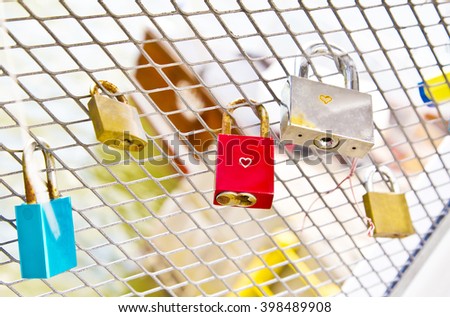  hanged lockers on a fence ,helsinki ,red ,pink ,blue ,love ,vintage ,river , finland  ,  promises ,metal ,bridge ,engagement, romance, happy, symbol of love ,happiness 