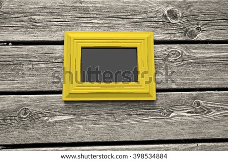 White wooden floor with yellow picture frame and chalkboard