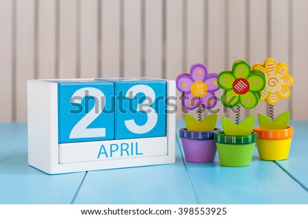 April 23rd. World Book Day. Image of april 23 wooden color calendar on white background with flowers. Spring day, empty space for text Royalty-Free Stock Photo #398553925
