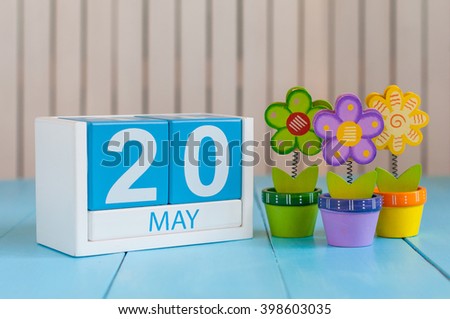 May 20th. Image of may 20 wooden color calendar on white background with flower. Spring day, empty space for text. World Metrology Day