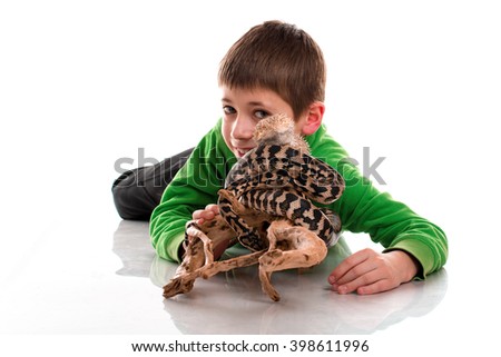 Cute boy with a very beautiful lizard and a snake on a white background