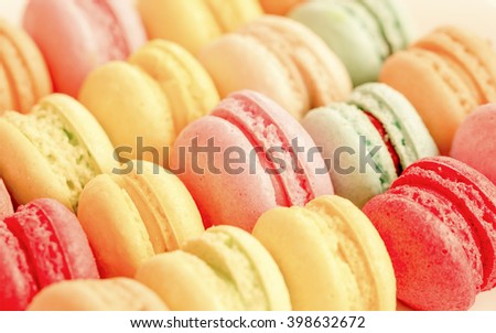 Sweet and colourful french macaroons on retro-vintage soft blur for background
