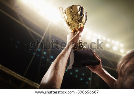 Athlete holding trophy cup Royalty-Free Stock Photo #398656687