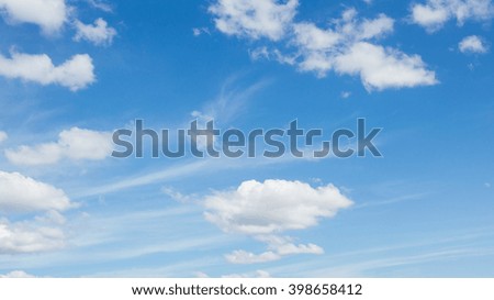 clear blue sky and fluffy cloud background