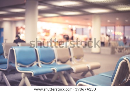 Blurred waiting room with empty chairs in pink tone