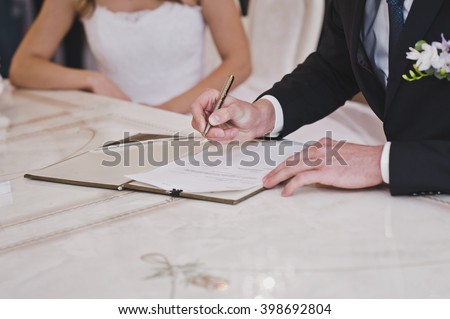 A man signs an important document. Royalty-Free Stock Photo #398692804