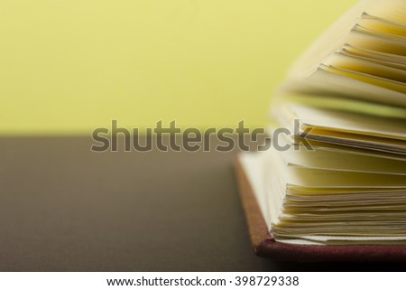 Macro view of book pages on colorful paper background. Copy space for text.