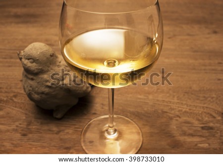 Bird decoration object and glass of white wine