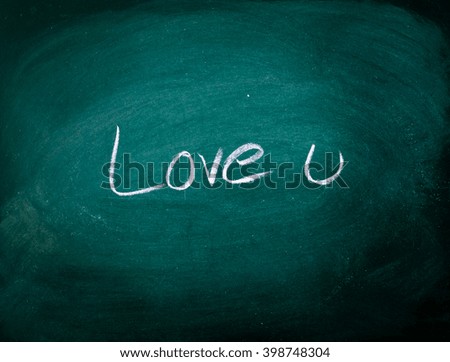 text "love u", written in chalk on dark background 