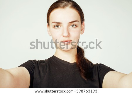 young pretty teenage girl making selfie isolated on white background close up