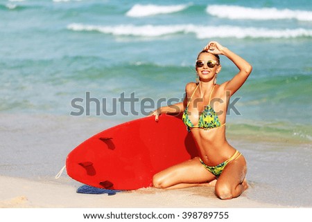 Beautiful young girl with surfboard