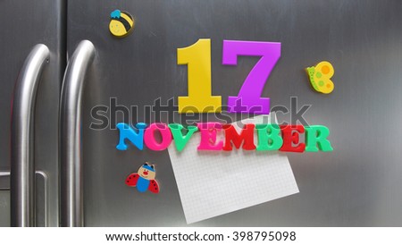 November 17 calendar date made with plastic magnetic letters holding a note of graph paper on door refrigerator