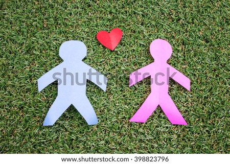 Paper Couple on Green Grass Background.