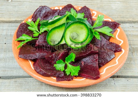 Beetroot in a clay plate on a wooden table