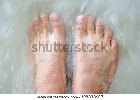 Blurry picture of woman feet in water