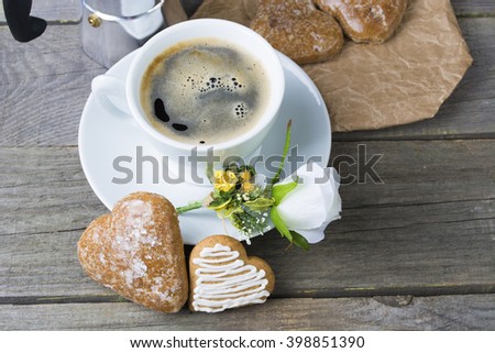 Heart shaped cookies , cup of coffee, white rose decoration, coffee maker. Romantic Breakfast. Toned, selected focus image