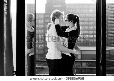 Beautiful young girl kissing her boyfriend, wonderful couple photo in last light of the sun