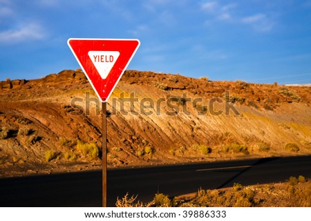 Yield Sign at Sunrise on a Desert Road.