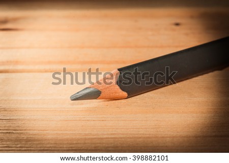 Close up of pencil on wooden background. Macro with extremely shallow depth of field. Vintage tone.
