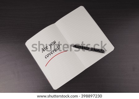 Are You Covered written on notebook, business and insurance conceptual