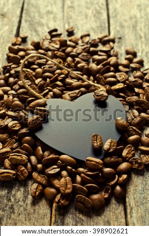 Board for records in the whole coffee beans on a wooden background. Selective focus.