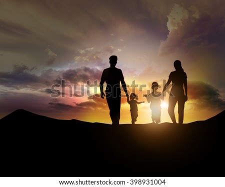 silhouette of family facing the sunset