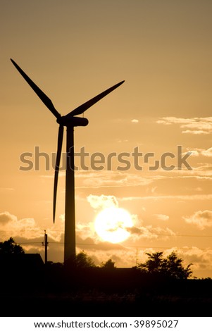 A wind turbine at sunset.