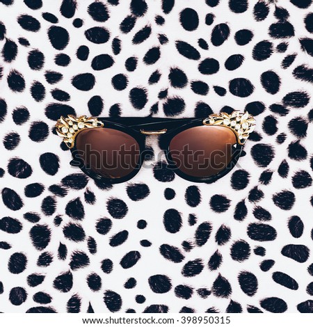 Glamorous Sunglasses on leopard print background. Minimalism Fashion
