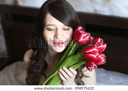 Girl with red flowers in the bed 1