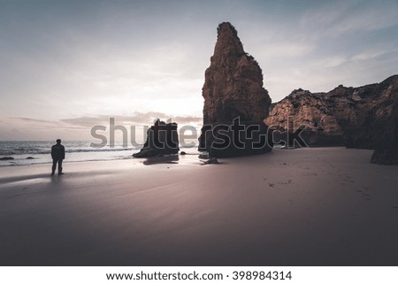 Man on the rocky coastline of Atlantic ocean, Algarve, Portugal
