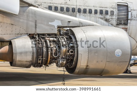 Damaged jet engine on large aircraft Royalty-Free Stock Photo #398991661