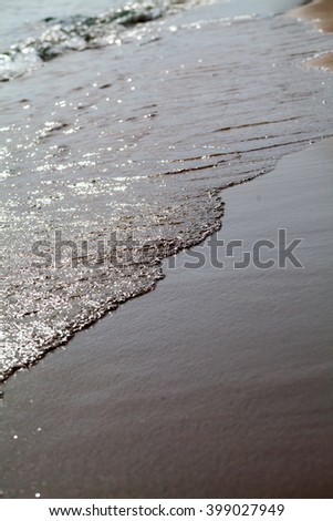 Wave and sand closeup
