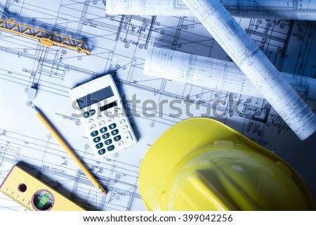 Construction concept. Construction theme, level, ruler, calculator, blueprints rolls, hard hat and pencil Royalty-Free Stock Photo #399042256