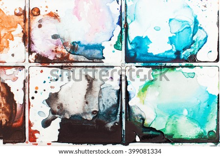 Stains watercolor paints on a palette. It can be used as an original background, space for text. The concept of creativity, drawing education, bright ideas, etc.