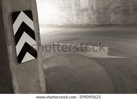 Empty parking lot floor and wall with white arrow. Composition can be used as background.