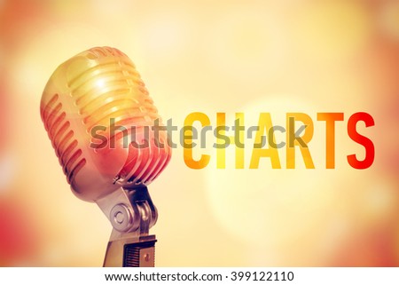 Stage microphone on a glowing abstract background with an inscription Charts. Toned