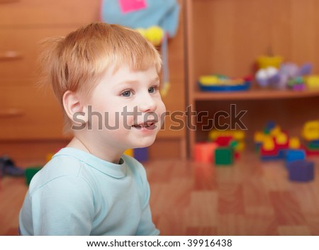 Portrait of the little boy in a children's room