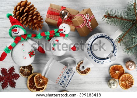 Christmas background. Decorations, cones, gift boxes on white wooden background