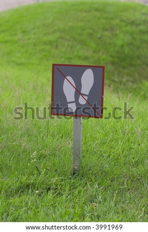 "Don't walk" sign on green lawn
