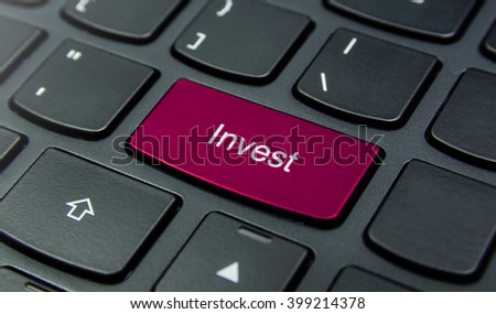 Business Concept: Close-up the Invest button on the keyboard and have Magenta color button isolate black keyboard