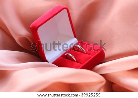 Two Platinum wedding rings in red box