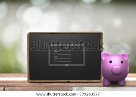Saving plan concept, piggy bank and blackboard on wood table over blur nature background