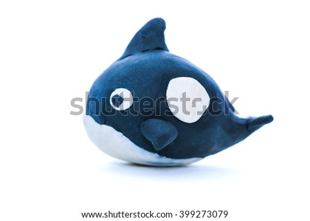 Cartoon black whale model from clay. Isolated on white background. Play dough animal. Studio shot.