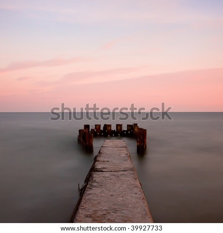 seascape with old pier at sunset